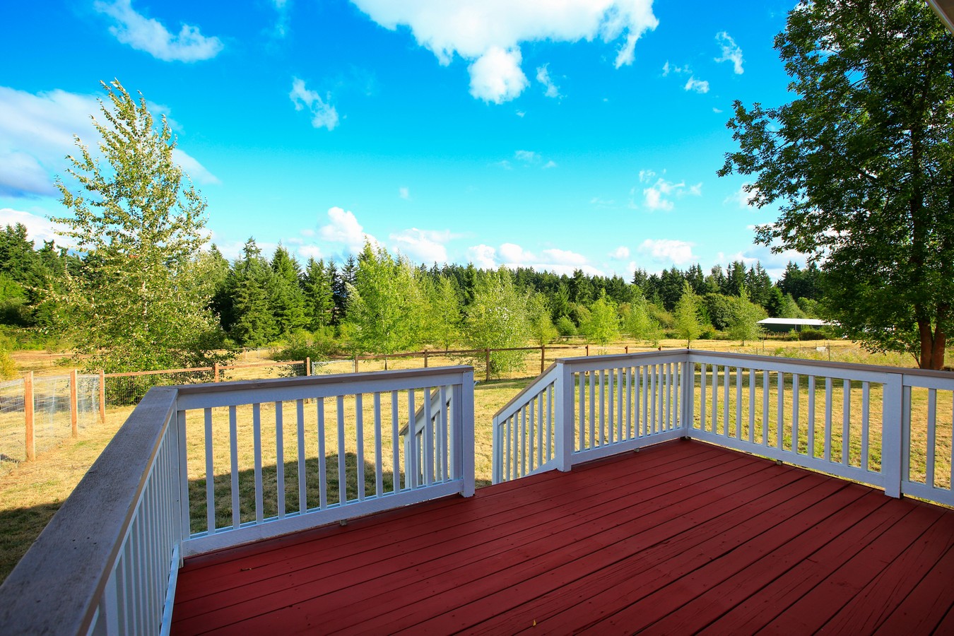 Coastal deck with white timber balustrade on Bribie Island property