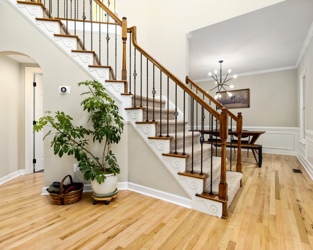 Internal staircase with timber handrail and wrought iron balusters in Bray Park home