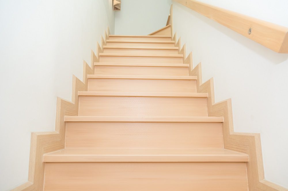 Light timber straight flight staircase in Taigum home