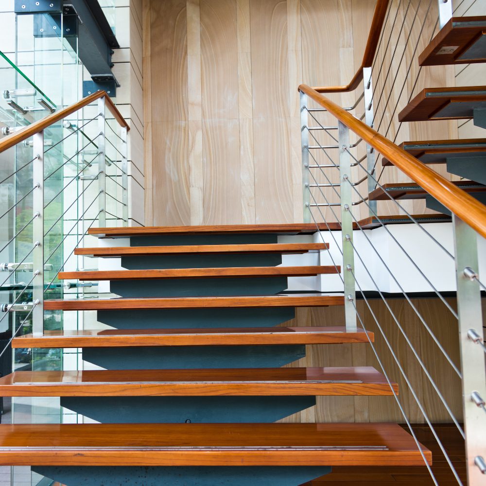 Open-tread timber staircase with glass and wire balustrade in Northgate home