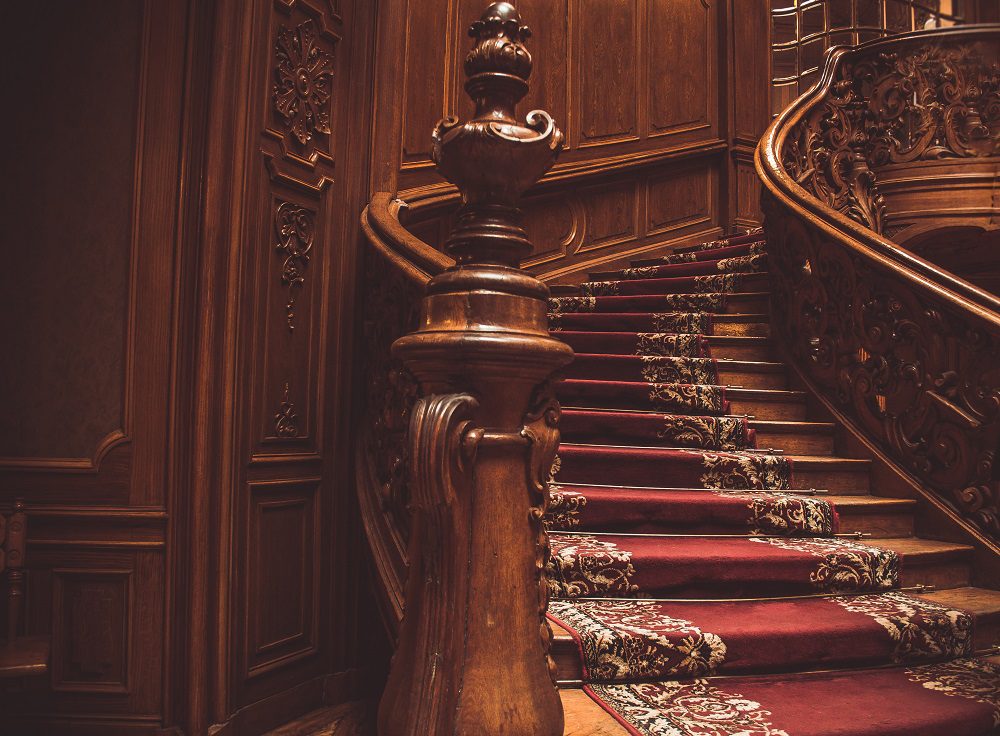 Ornate carved timber staircase in Arana Hills heritage home