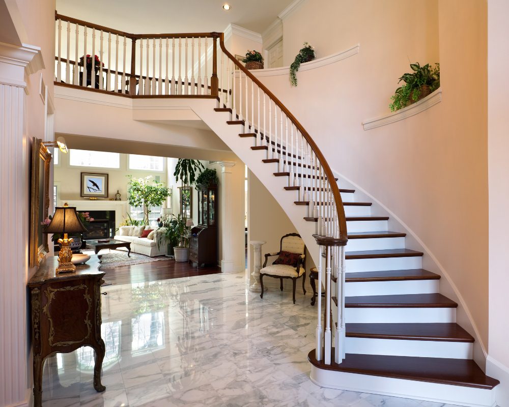 Grand curved traditional staircase with hardwood treads in Clayfield home